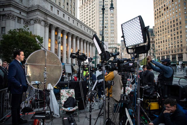 Members of the press outside the court building