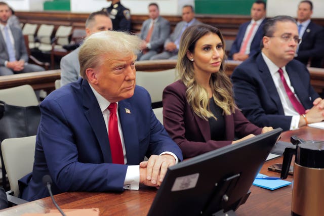 Donald Trump sits in the courtroom with his legal team