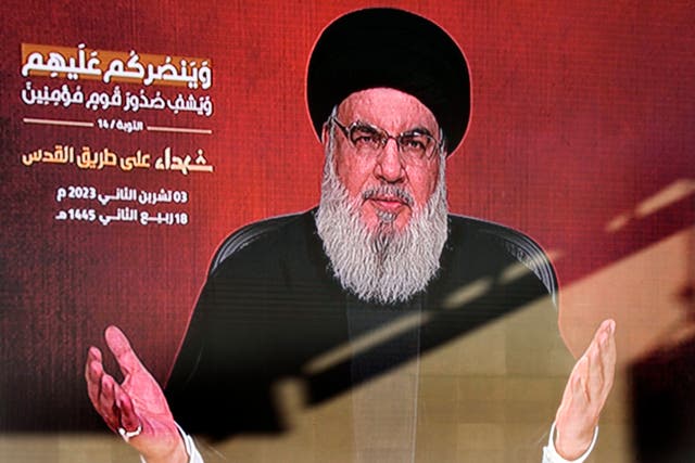 Hezbollah leader Hassan Nasrallah greets his supporters via video link