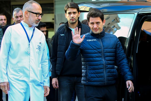 Meler waves to on-lookers after leaving hospital on Wednesday