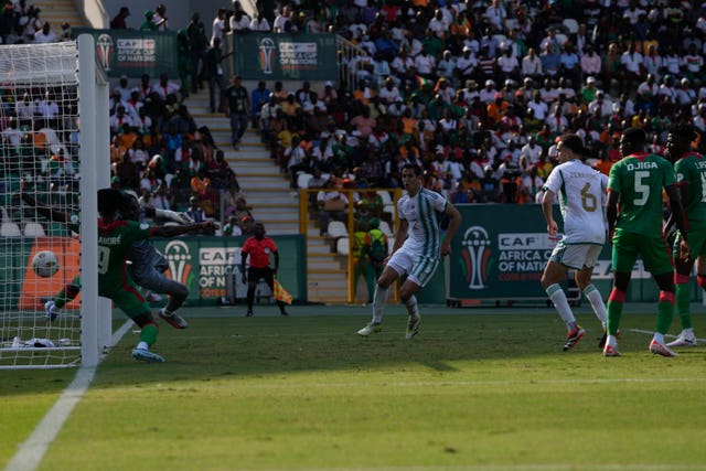 Algeria’s Baghdad Bounedjah, not seen, scores his side’s equaliser against Burkina Faso