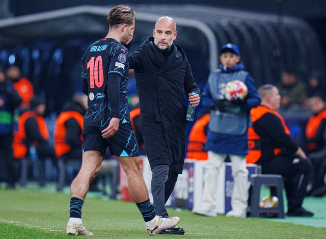 Pep Guardiola greets Jack Grealish, left, as he is substituted against FC Copenhagen