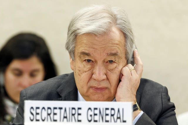 UN Secretary-General Antonio Guterres in front of nameplate reading Secretaire General