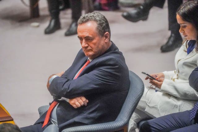 Israel Katz sitting on a chair with his arms folded