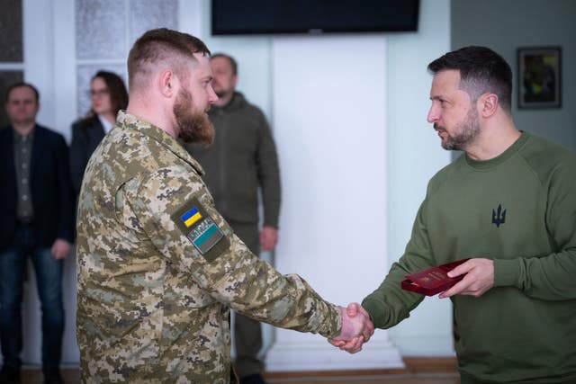 Ukrainian president Volodymyr Zelensky, right, awards servicemen earlier this month 