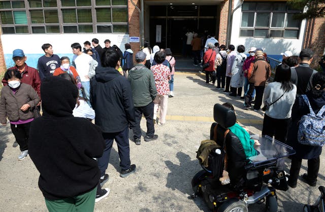 People wait in line to cast their votes