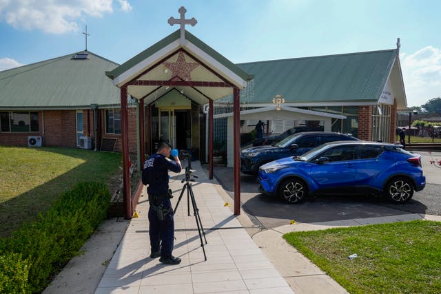 A police forensic officer works at a crime scene at the Christ the Good Shepherd church in Wakely in western Sydney 
