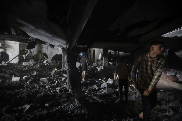 Palestinians search for survivors after an Israeli air strike on a residential building in Rafah refugee camp, southern Gaza Strip