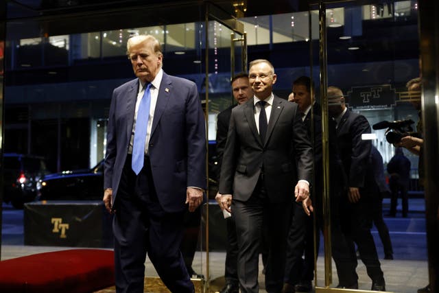 Republican presidential candidate former President Donald Trump walks with Poland’s President Andrzej Duda