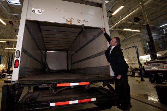 Police officers open the back of a recovered truck during a press conference regarding Project 24K a joint investigation into the theft of gold from Pearson International Airport, in Brampton, Ontario