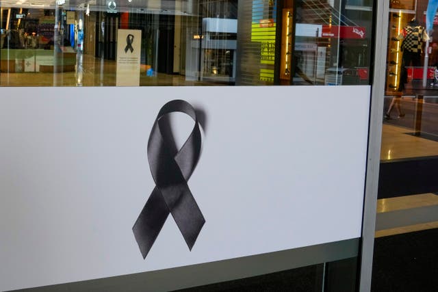 Black ribbons are displayed on the doors to the Westfield shopping centre 