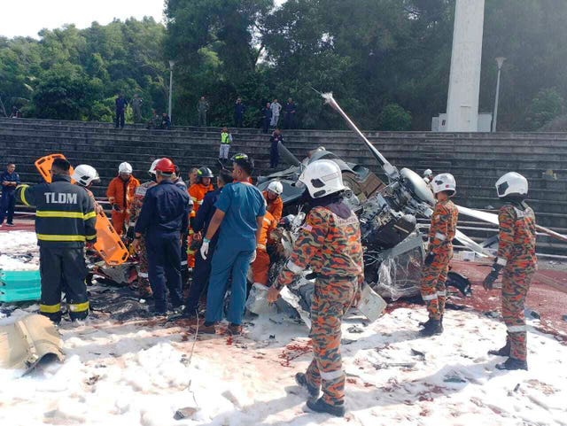 Fire and rescue workers inspect the crash site 