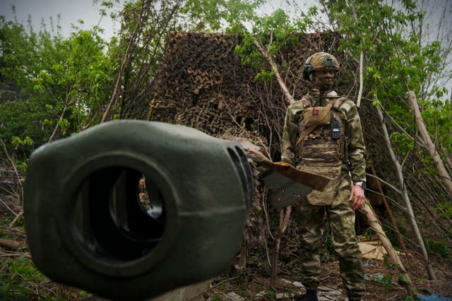 A Russian soldier stands by a 2A65 'Msta-B' howitzer