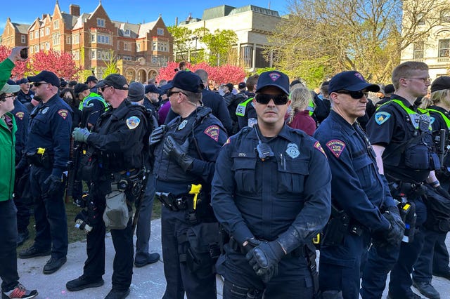 Police in the US gather as they start removing tents erected by protesters from the campus of University of Wisconsin 