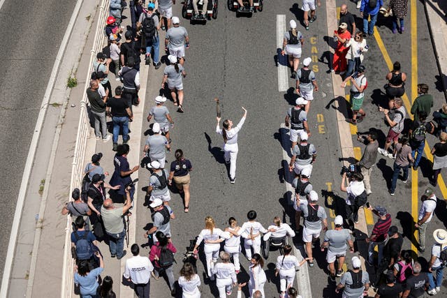 Crowds watch the Olympic torch relay in Marseille