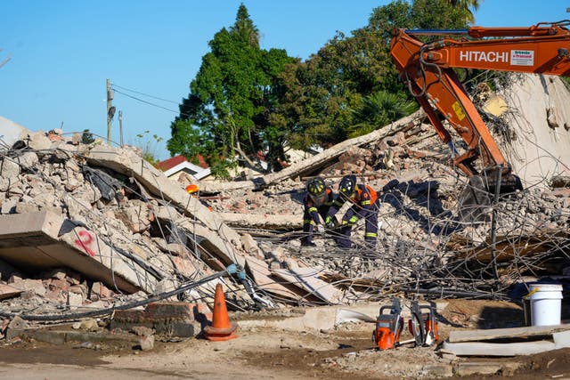 Rescue personnel search the site of a building collapse in George, South Africa