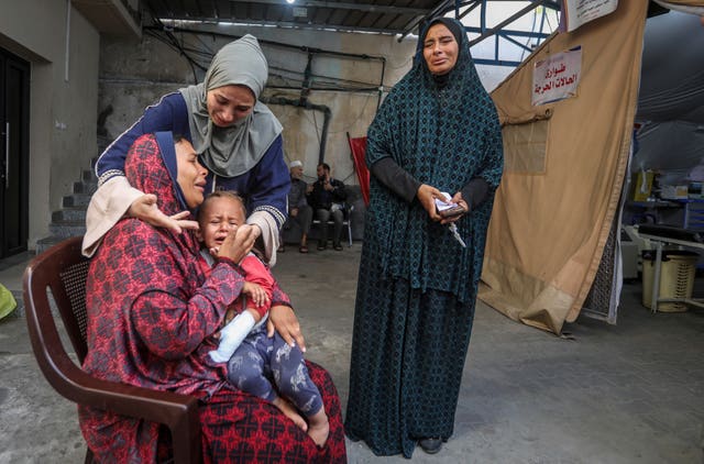 Palestinians mourn their relatives at a hospital in Rafah, Gaza