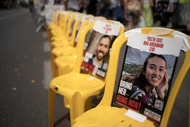A poster of Noa Argamani is taped to one of the empty chairs for hostages held by Hamas in the Gaza Strip as relatives and their supporters gather together to mark the start of Shabbat, outside of Israeli Prime Minister Benjamin Netanyahu’s official residence to call for an immediate deal to release their loved ones, in Jerusalem