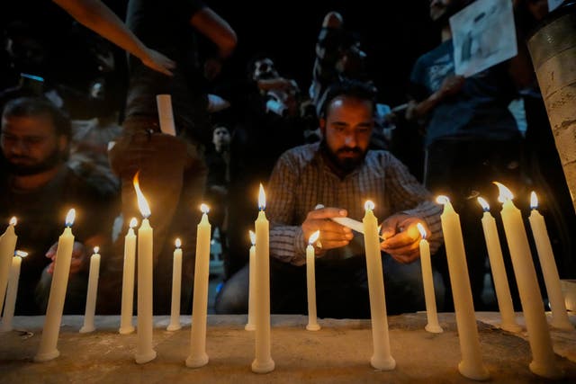 Candles are lit in memory of Mr Raisi and others killed in the helicopter crash
