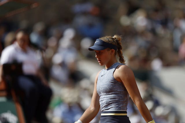 Mirra Andreeva walks across the court