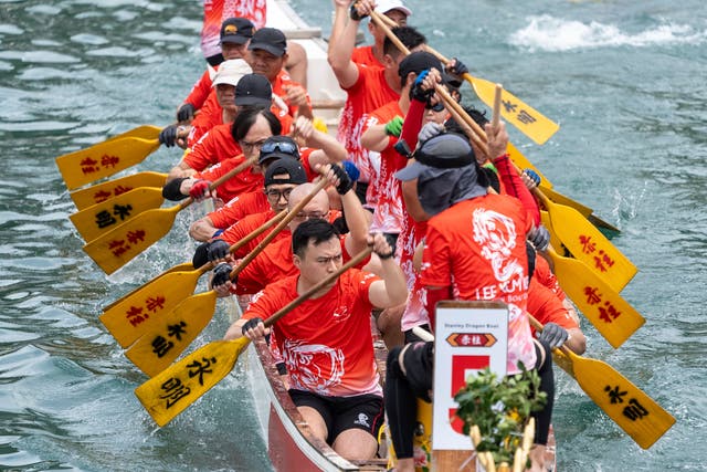 People in red paddling a boat