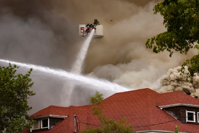 Firefighters working to tackle the blaze in Miami as smoke billows from the building