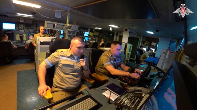 Navy personnel taking part in drills on board a Russian frigate