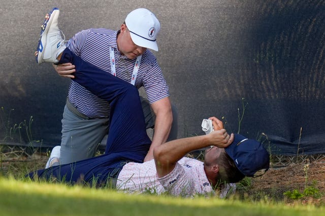 Bryson DeChambeau receives physio treatment