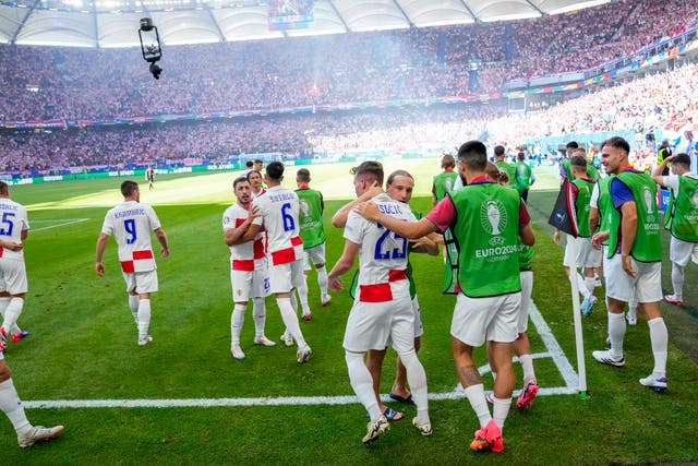 Crotia players walk back to their own half after celebrating their second goal against Albania