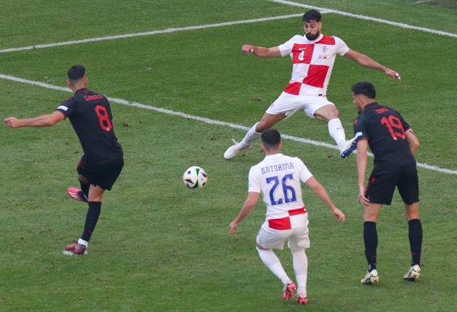 Klaus Gjasula curls the ball past a defender and into the bottom corner to secure Albania a draw against Croatia