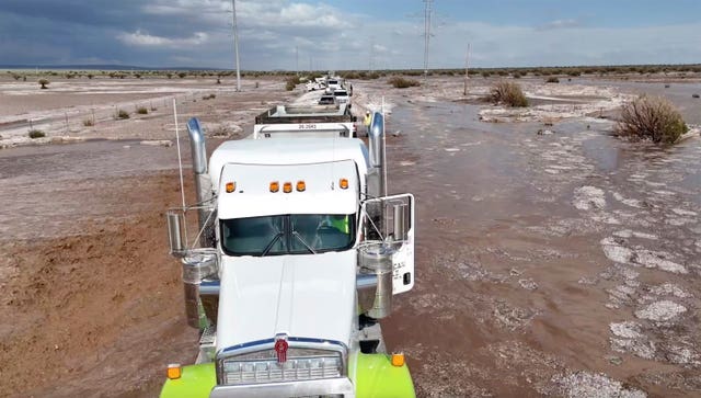 Floding on the roads with a truck in the foreground