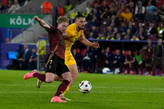 Kevin De Bruyne, left, scores for Belgium against Romania