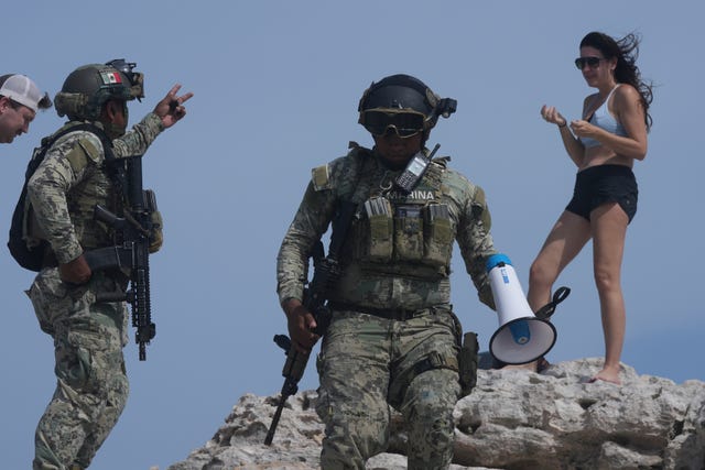 Soldiers ask a tourist to evacuate Mirador beach ahead of Hurricane Beryl’s expected arrival in Tulum, Mexico