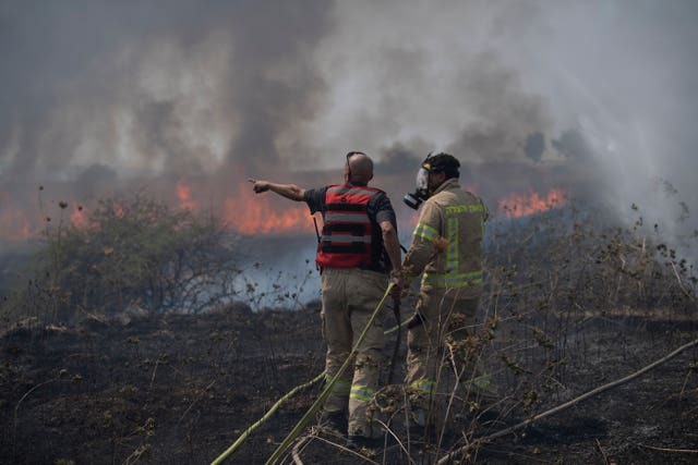 Firefighters surrounded by smoke