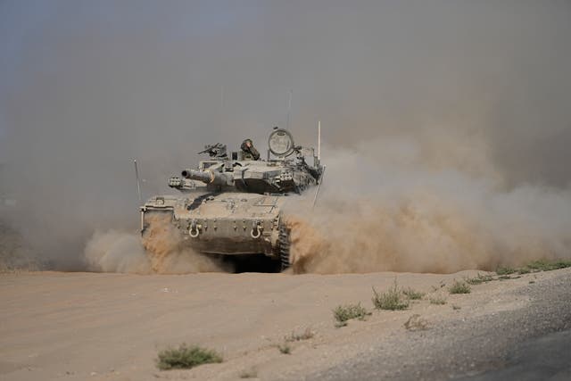 An Israeli tank on the move near the Israel-Gaza border in southern Israel