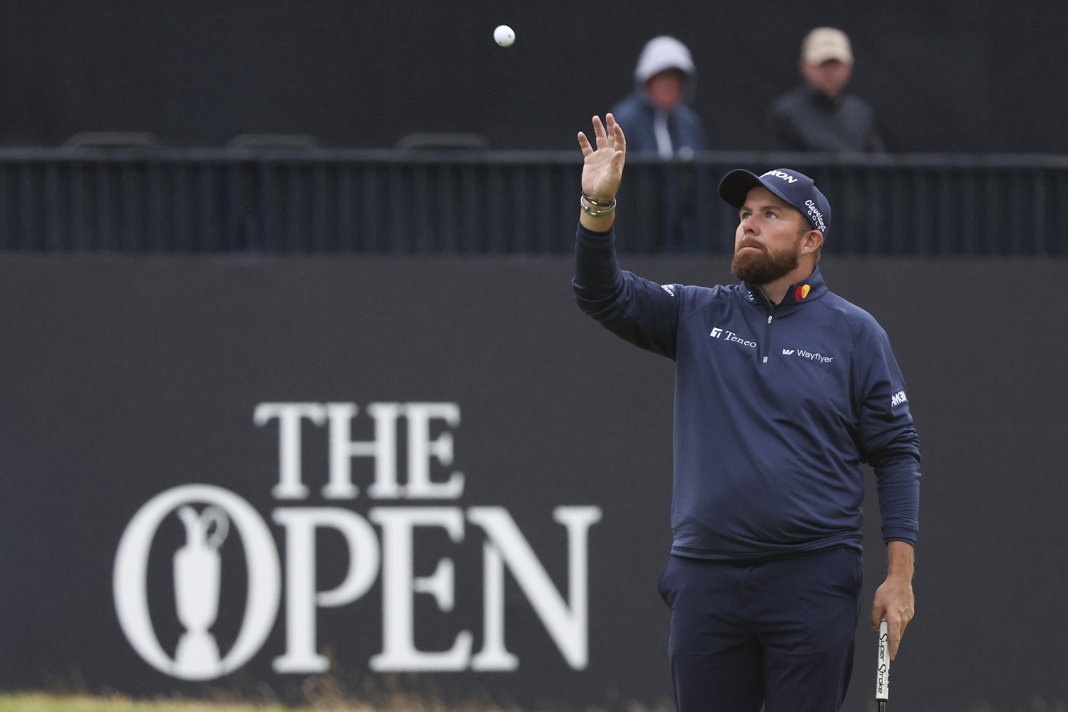 Shane Lowry holds his hand out to catch a ball