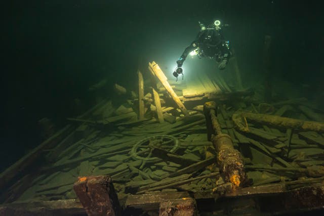 A diver from the Polish team inspects the wreckage