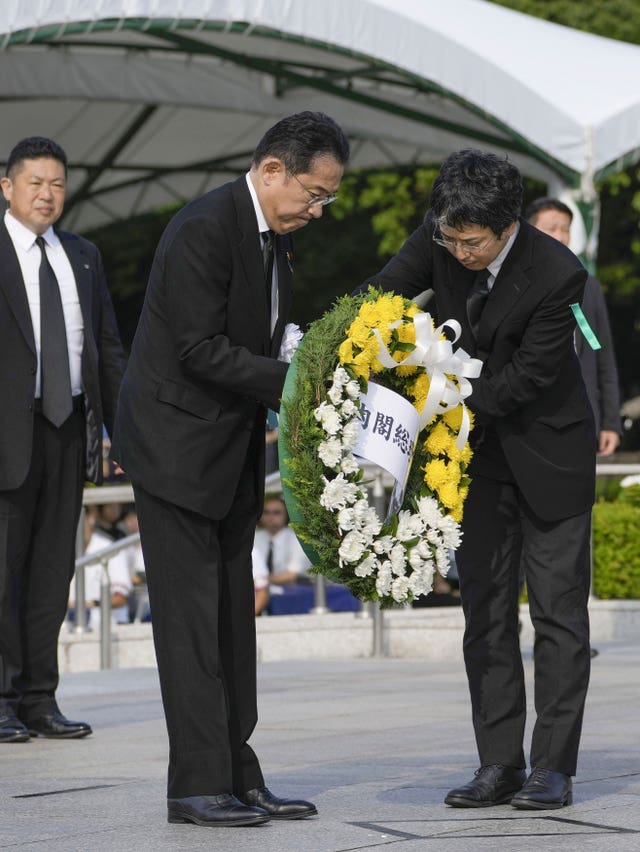 Japan’s Prime Minister Fumio Kishida prepares to lay a wreath at the cenotaph dedicated to the victims of the atomic bombing
