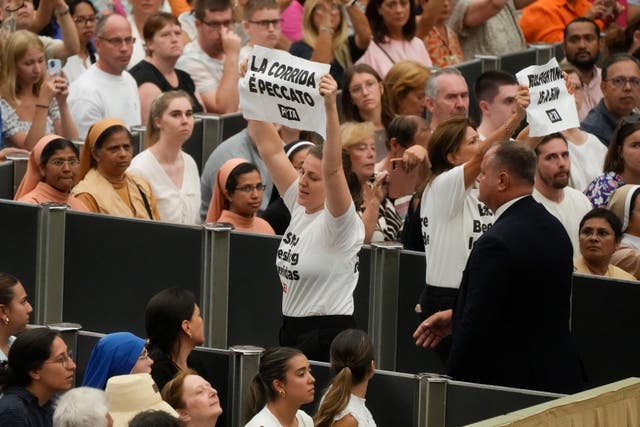 Protesters wear t-shirts reading 'stop blessing corridas'