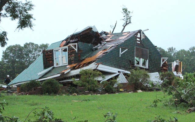 A house is damaged by a tornado