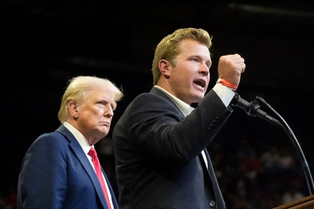 Republican presidential nominee former President Donald Trump listens as Montana Senate candidate Tim Sheehy speaks at a campaign rally