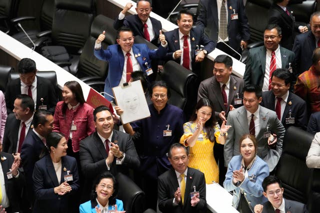 Pheu Thai party legislators celebrate after Thailand’s parliament elected the party’s leader Paetongtarn Shinawatra as the country’s new prime minister at parliament in Bangkok