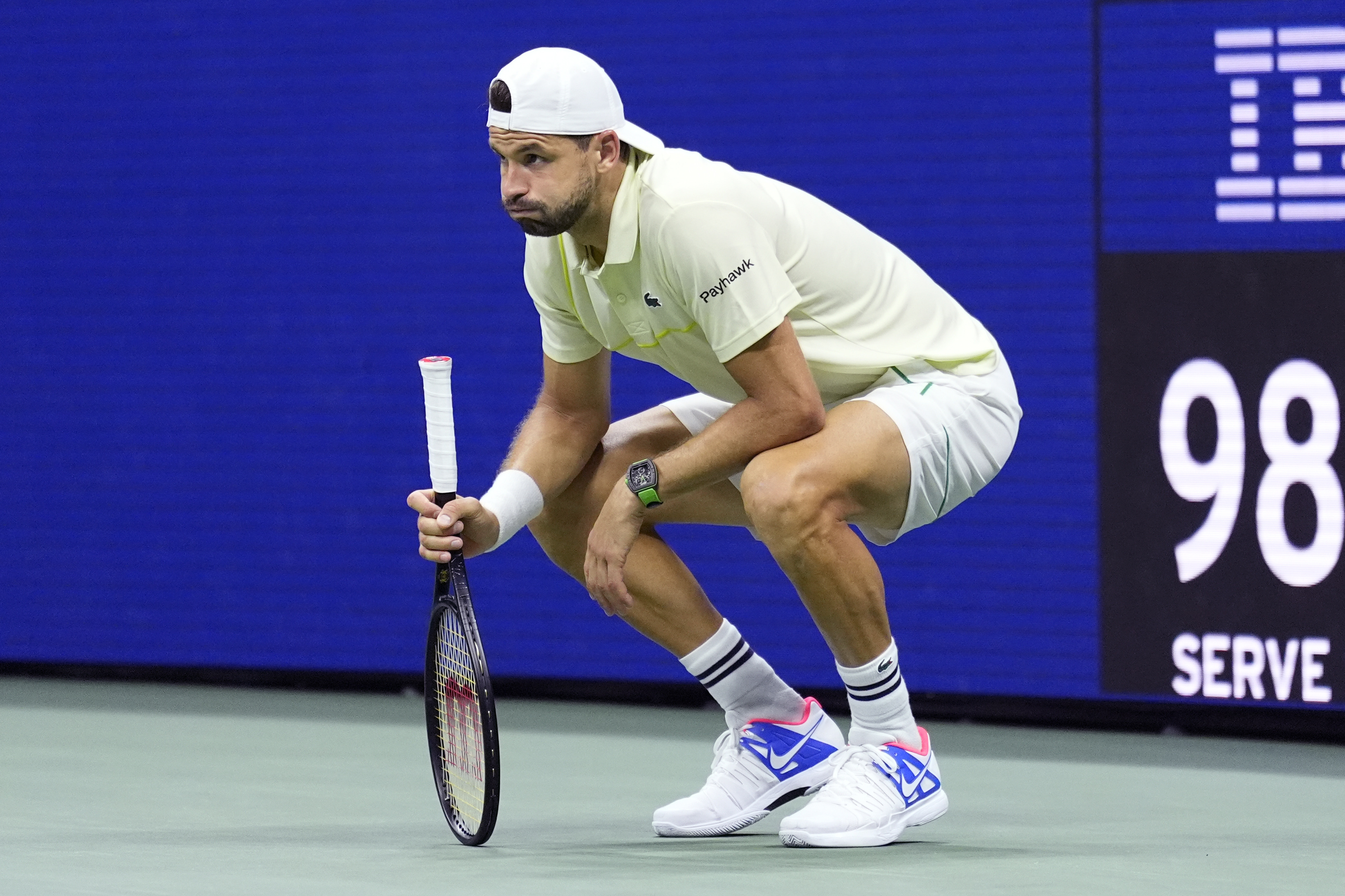 Grigor Dimitrov crouches down in pain