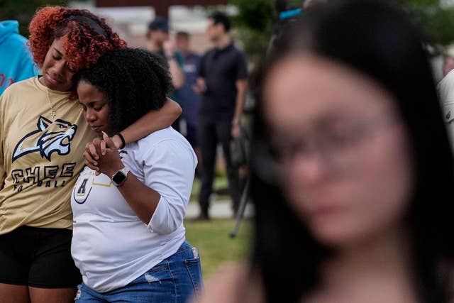 Mourners pray during a candlelight vigil for the students and teachers killed at Apalachee High School in Georgia