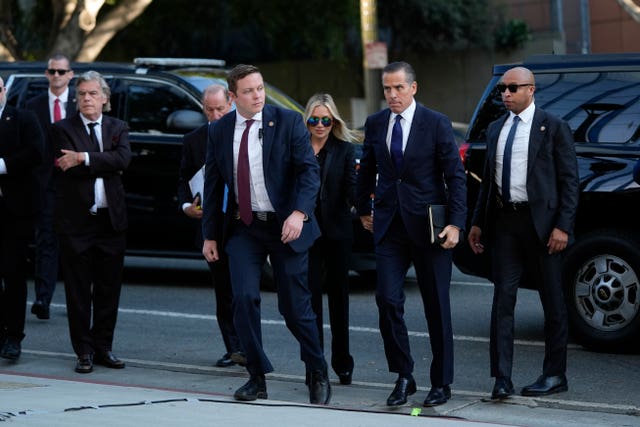 Hunter Biden, flanked by several security guards