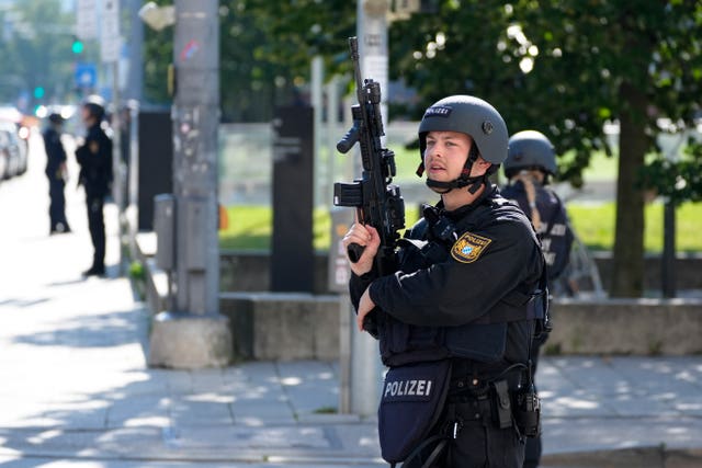 Police officers near the scene after police officers shot a suspect near the Israeli consulate and a museum on the Nazi history of the city of Munich 