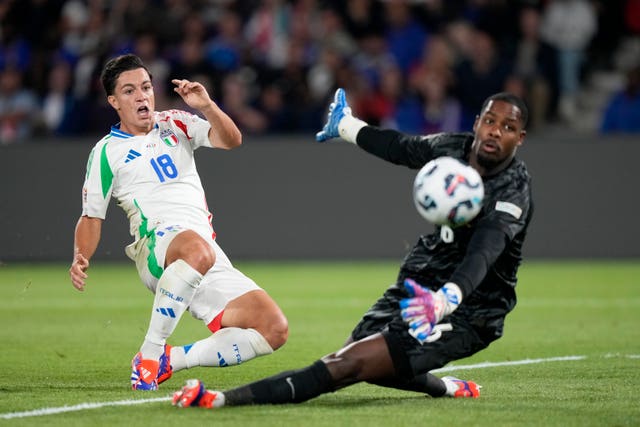 Giacomo Raspadori, left, pokes home Italy's third goal past France goalkeeper Mike Maignan