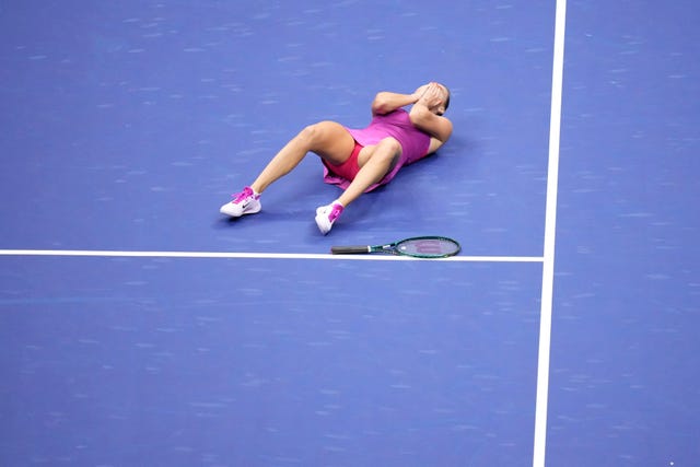 Aryna Sabalenka lies down on court