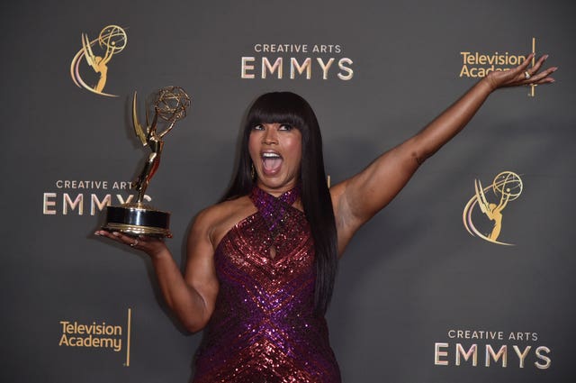 Angela Bassett poses with her award for outstanding narrator for Queens
