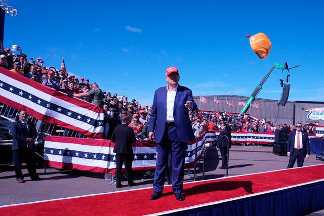 A hat is thrown at Mr Trump as he walks onto the stage